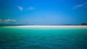 Shades of blue above and below a brilliant white sandbar, Raja Ampat, Indonesia