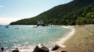 A coral beach on Fitzroy Island with a view over to the jetty