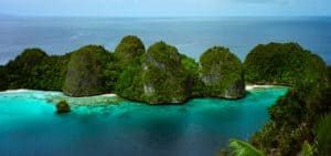 Island-hopping is the way to get around Wajag island and its karst islets, Raja Ampat, Indonesia