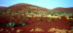 The vermilion earth contrasts against the morning sky in the Pilbara